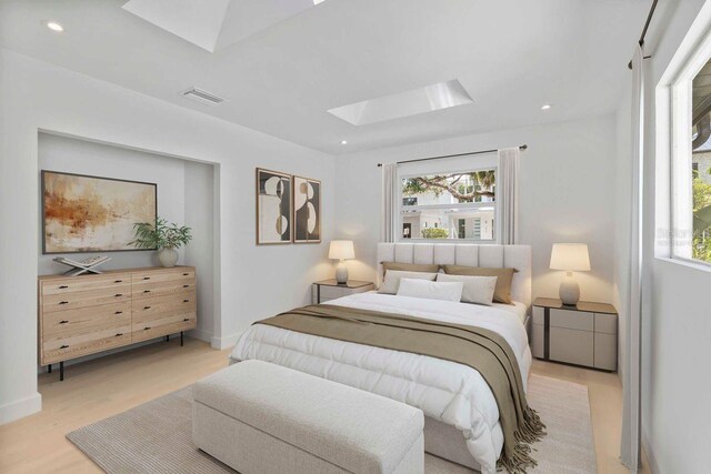 2410 Floyd St, Sarasota, FL 34239 - bedroom featuring a skylight, multiple windows, light wood-type flooring, and recessed lighting