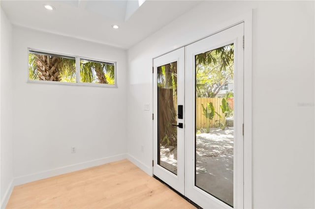 2410 Floyd St, Sarasota, FL 34239 - doorway to outside featuring light wood-type flooring, recessed lighting, and a skylight