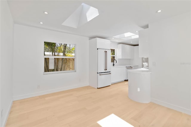 2410 Floyd St, Sarasota, FL 34239 - unfurnished living room with a skylight, light wood finished floors, and recessed lighting