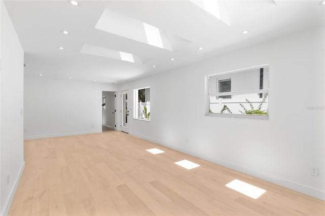 2410 Floyd St, Sarasota, FL 34239 - empty room featuring a skylight, plenty of natural light, light wood-style flooring, and recessed lighting