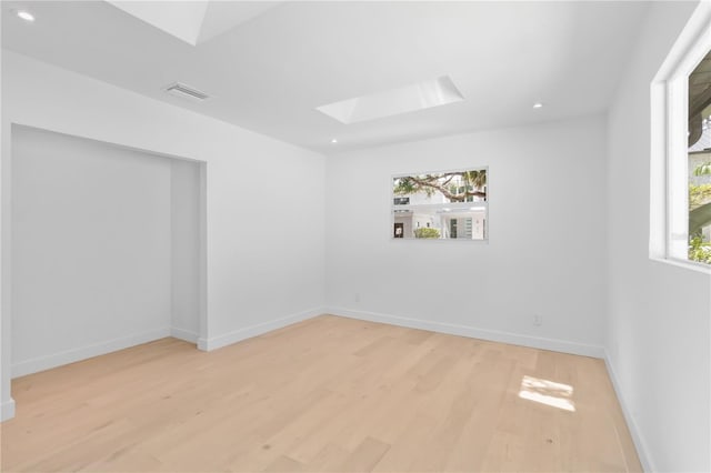 2410 Floyd St, Sarasota, FL 34239 - empty room with a skylight, light wood-type flooring, and recessed lighting