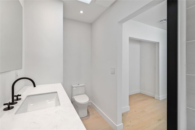 2410 Floyd St, Sarasota, FL 34239 - bathroom featuring vanity, recessed lighting, and wood finished floors