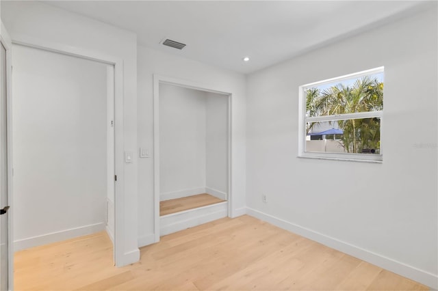 2410 Floyd St, Sarasota, FL 34239 - unfurnished bedroom featuring light wood-style flooring and recessed lighting