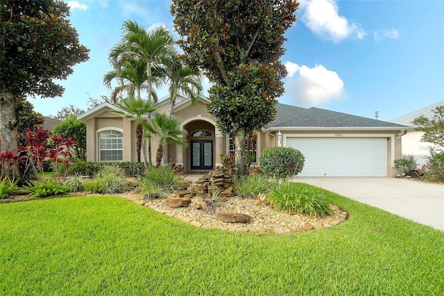 5905 32nd St E, Ellenton, FL 34222 - view of front of home with french doors, stucco siding, a front yard, and concrete driveway