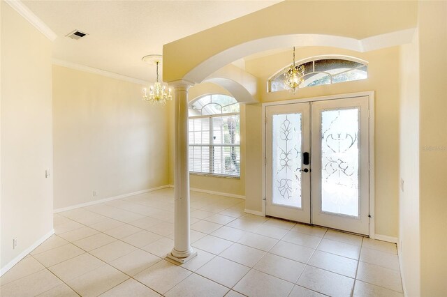 5905 32nd St E, Ellenton, FL 34222 - tiled foyer with a chandelier, arched walkways, french doors, plenty of natural light, and crown molding