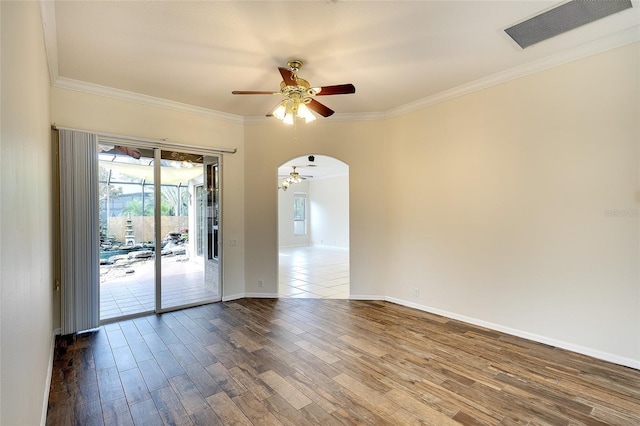 5905 32nd St E, Ellenton, FL 34222 - unfurnished room featuring ceiling fan, dark wood-style flooring, ornamental molding, and arched walkways