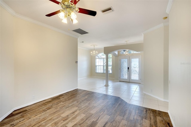 5905 32nd St E, Ellenton, FL 34222 - spare room featuring french doors, ornamental molding, a chandelier, wood finished floors, and ceiling fan
