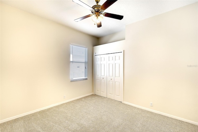 5905 32nd St E, Ellenton, FL 34222 - unfurnished bedroom featuring light colored carpet, a closet, and a ceiling fan