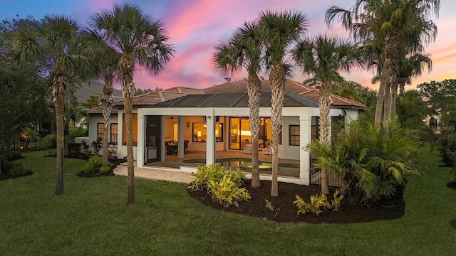 8312 Catamaran Cir, Lakewood Ranch, FL 34202 - rear view of house with stucco siding, a tiled roof, a yard, and a patio area