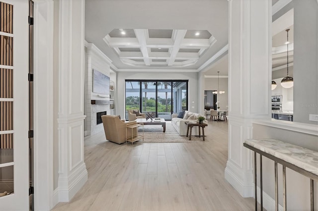 8312 Catamaran Cir, Lakewood Ranch, FL 34202 - hall featuring light wood finished floors, beamed ceiling, coffered ceiling, crown molding, and a towering ceiling