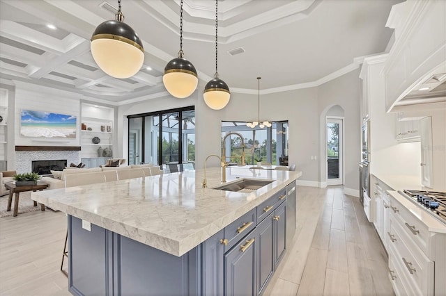 8312 Catamaran Cir, Lakewood Ranch, FL 34202 - kitchen featuring a sink, white cabinetry, healthy amount of natural light, ornamental molding, and recessed lighting