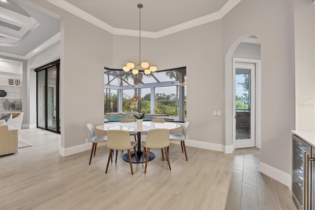 8312 Catamaran Cir, Lakewood Ranch, FL 34202 - dining space featuring beverage cooler, plenty of natural light, arched walkways, baseboards, and ornamental molding