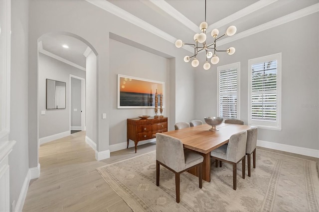 8312 Catamaran Cir, Lakewood Ranch, FL 34202 - dining space with arched walkways, ornamental molding, light wood finished floors, baseboards, and a chandelier
