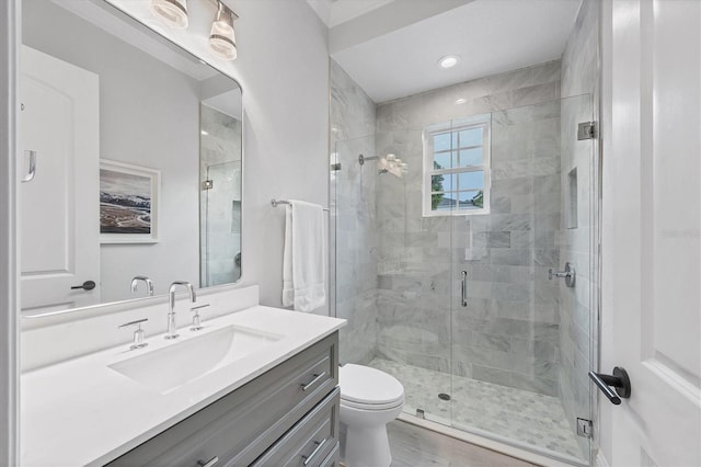 8312 Catamaran Cir, Lakewood Ranch, FL 34202 - bathroom featuring vanity, a shower stall, toilet, and wood finished floors