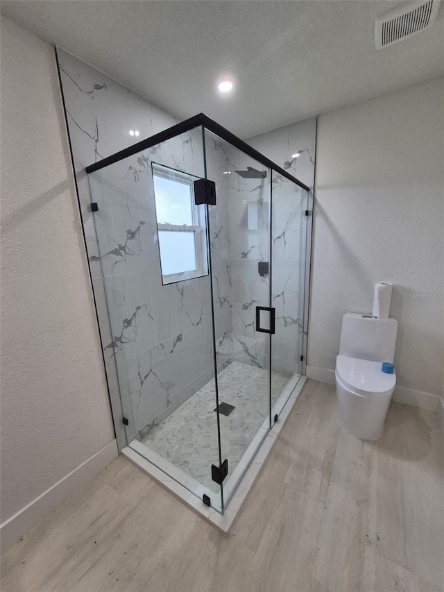 6572 Mauna Loa Blvd, Sarasota, FL 34241 - full bathroom with wood finished floors, toilet, baseboards, and a marble finish shower