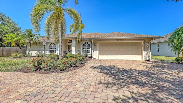5698 Country Walk Ln, Sarasota, FL 34233 - view of front of house with stucco siding, decorative driveway, and an attached garage
