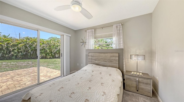 5698 Country Walk Ln, Sarasota, FL 34233 - carpeted bedroom with access to exterior, multiple windows, ceiling fan, and baseboards