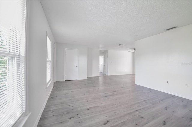 478 Orange Dr NW, Port Charlotte, FL 33952 - empty room featuring wood finished floors, a textured ceiling, and baseboards
