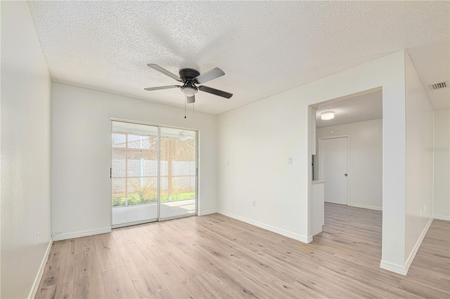 478 Orange Dr NW, Port Charlotte, FL 33952 - spare room featuring a ceiling fan, light wood-type flooring, a textured ceiling, and baseboards
