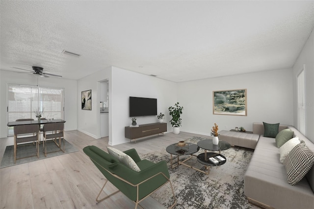 478 Orange Dr NW, Port Charlotte, FL 33952 - living area featuring wood finished floors, a ceiling fan, baseboards, and a textured ceiling