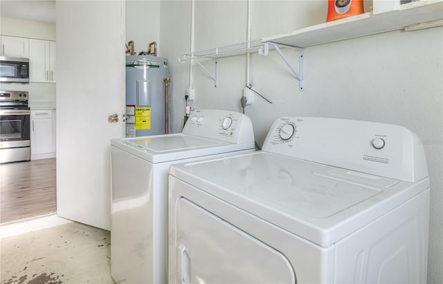 478 Orange Dr NW, Port Charlotte, FL 33952 - laundry room featuring electric water heater and washing machine and clothes dryer