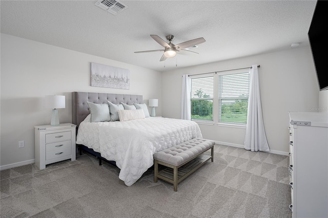 9148 Royal River Cir, Parrish, FL 34219 - bedroom with light carpet, a ceiling fan, a textured ceiling, and baseboards