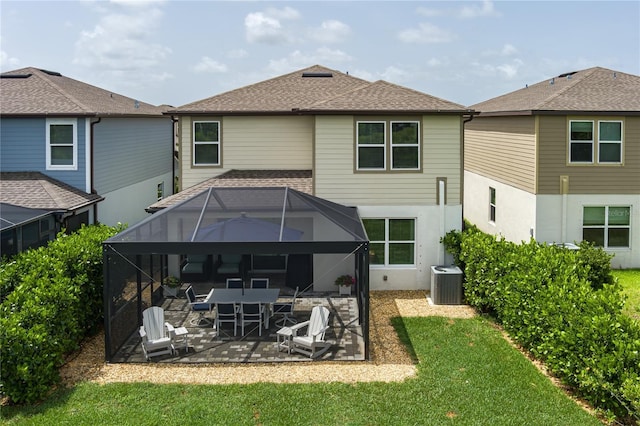 9148 Royal River Cir, Parrish, FL 34219 - rear view of property featuring a patio, cooling unit, glass enclosure, a yard, and stucco siding