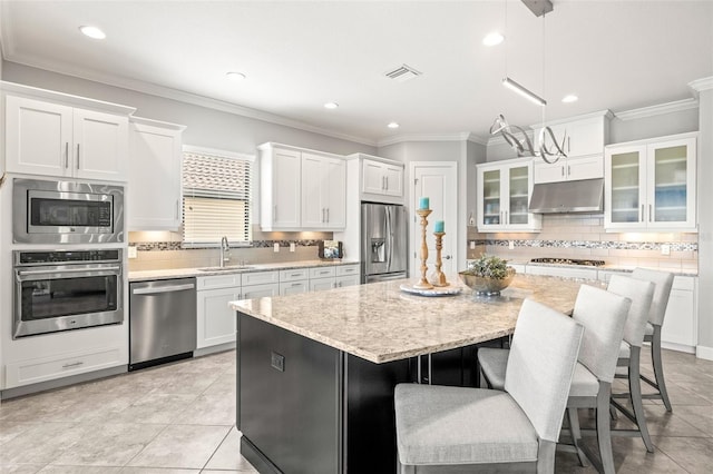 5011 Tivoli Run, Bradenton, FL 34211 - kitchen with appliances with stainless steel finishes, under cabinet range hood, a sink, white cabinetry, and recessed lighting