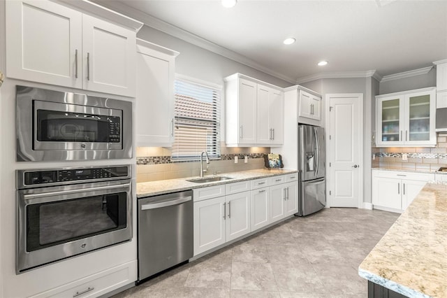 5011 Tivoli Run, Bradenton, FL 34211 - kitchen with stainless steel appliances, a sink, white cabinetry, backsplash, and recessed lighting