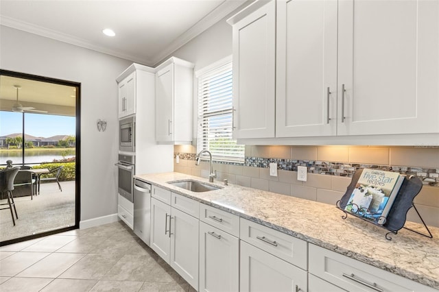 5011 Tivoli Run, Bradenton, FL 34211 - kitchen featuring a sink, appliances with stainless steel finishes, decorative backsplash, baseboards, and ornamental molding