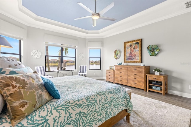 5011 Tivoli Run, Bradenton, FL 34211 - bedroom with a tray ceiling, ornamental molding, wood finished floors, baseboards, and ceiling fan