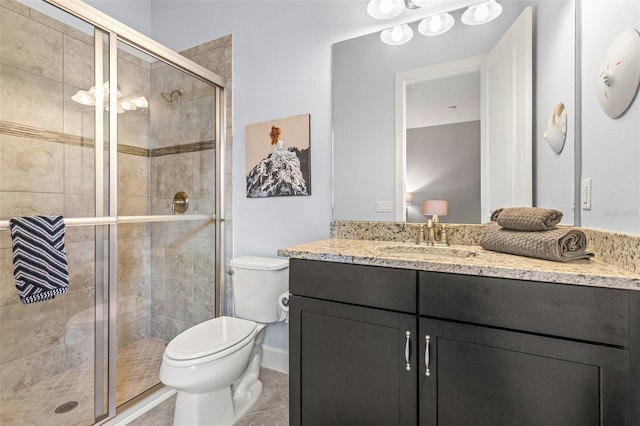 5011 Tivoli Run, Bradenton, FL 34211 - bathroom featuring toilet, vanity, a stall shower, and tile patterned floors