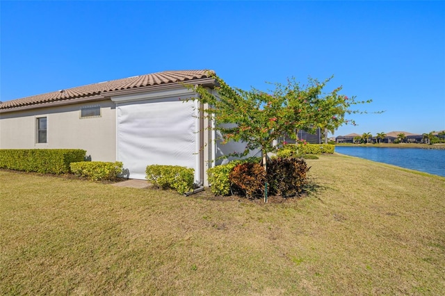 5011 Tivoli Run, Bradenton, FL 34211 - view of property exterior featuring a yard, a water view, a tile roof, and stucco siding