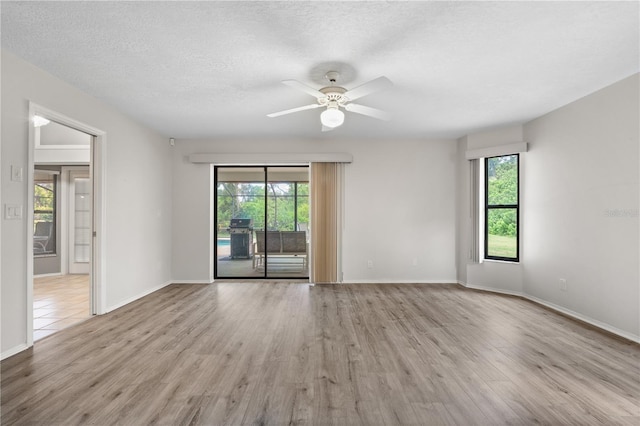 4622 34th Ct E, Bradenton, FL 34203 - unfurnished room with wood finished floors, ceiling fan, baseboards, and a textured ceiling
