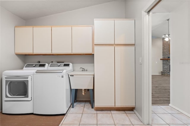 4622 34th Ct E, Bradenton, FL 34203 - laundry room featuring cabinet space, washer and clothes dryer, light tile patterned floors, and baseboards