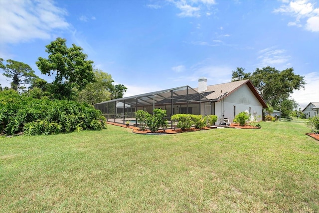 4622 34th Ct E, Bradenton, FL 34203 - back of property featuring a lawn, a chimney, and glass enclosure