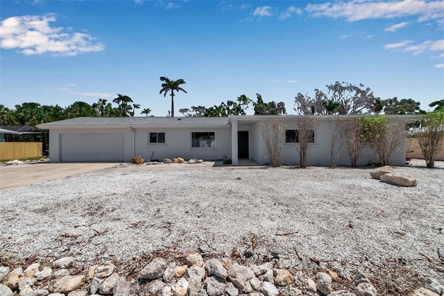 130 N Adams Dr, Sarasota, FL 34236 - view of front facade with stucco siding, driveway, and a garage