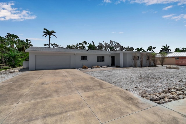 130 N Adams Dr, Sarasota, FL 34236 - view of front of property featuring a garage, driveway, and stucco siding