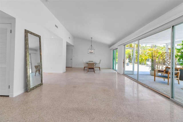 130 N Adams Dr, Sarasota, FL 34236 - empty room with speckle patterned floor, a chandelier, lofted ceiling, and baseboards