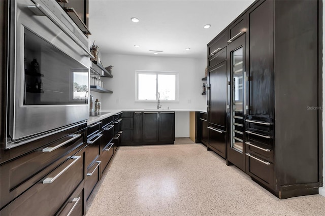 130 N Adams Dr, Sarasota, FL 34236 - kitchen featuring a sink, light countertops, recessed lighting, open shelves, and stainless steel oven