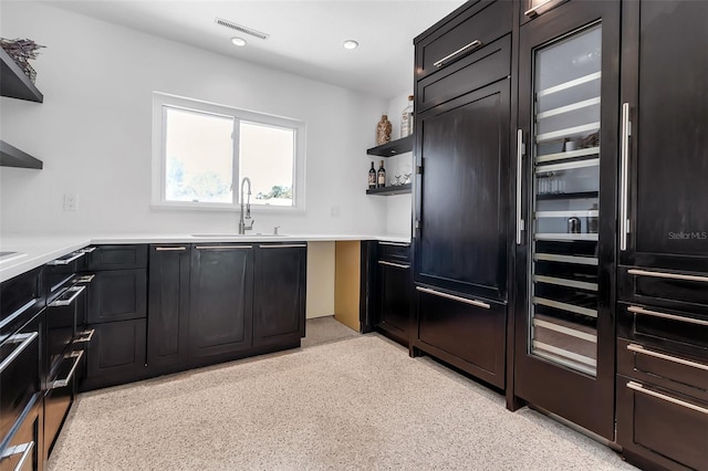 130 N Adams Dr, Sarasota, FL 34236 - kitchen featuring a sink, open shelves, light countertops, recessed lighting, and dark cabinetry