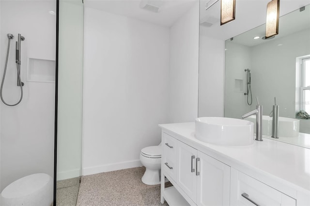 130 N Adams Dr, Sarasota, FL 34236 - bathroom with toilet, speckled floor, vanity, baseboards, and a shower