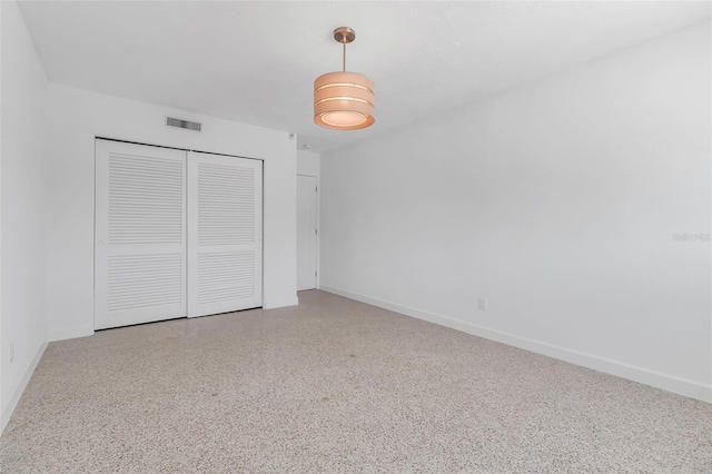 130 N Adams Dr, Sarasota, FL 34236 - unfurnished bedroom with a closet, baseboards, and speckled floor
