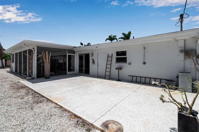 130 N Adams Dr, Sarasota, FL 34236 - back of property with a sunroom, a patio area, and stucco siding