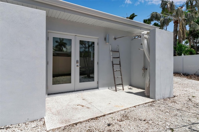 130 N Adams Dr, Sarasota, FL 34236 - view of exterior entry featuring french doors and stucco siding