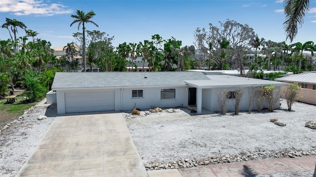 130 N Adams Dr, Sarasota, FL 34236 - view of front of house with an attached garage, concrete driveway, and stucco siding