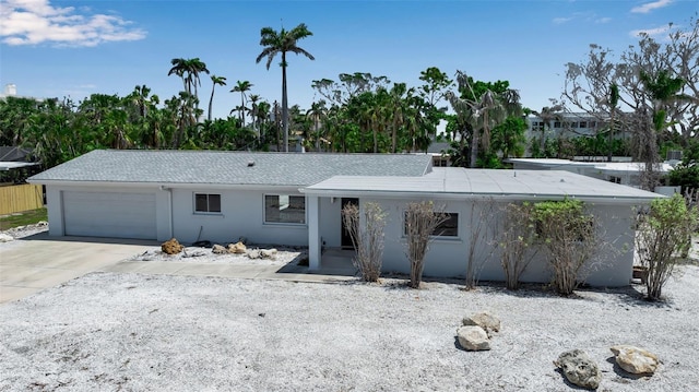 130 N Adams Dr, Sarasota, FL 34236 - view of front of property featuring stucco siding, an attached garage, and concrete driveway