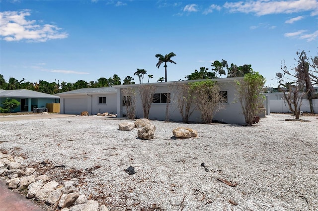 130 N Adams Dr, Sarasota, FL 34236 - view of front of property with stucco siding, concrete driveway, and an attached garage