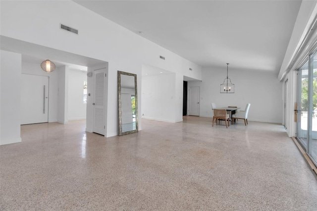 130 N Adams Dr, Sarasota, FL 34236 - unfurnished room featuring a chandelier, dark speckled floor, and a high ceiling