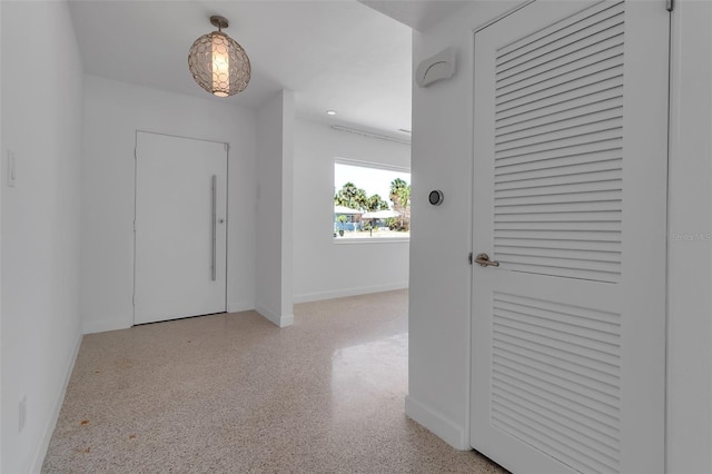 130 N Adams Dr, Sarasota, FL 34236 - hall with baseboards, speckle patterned floor, and recessed lighting